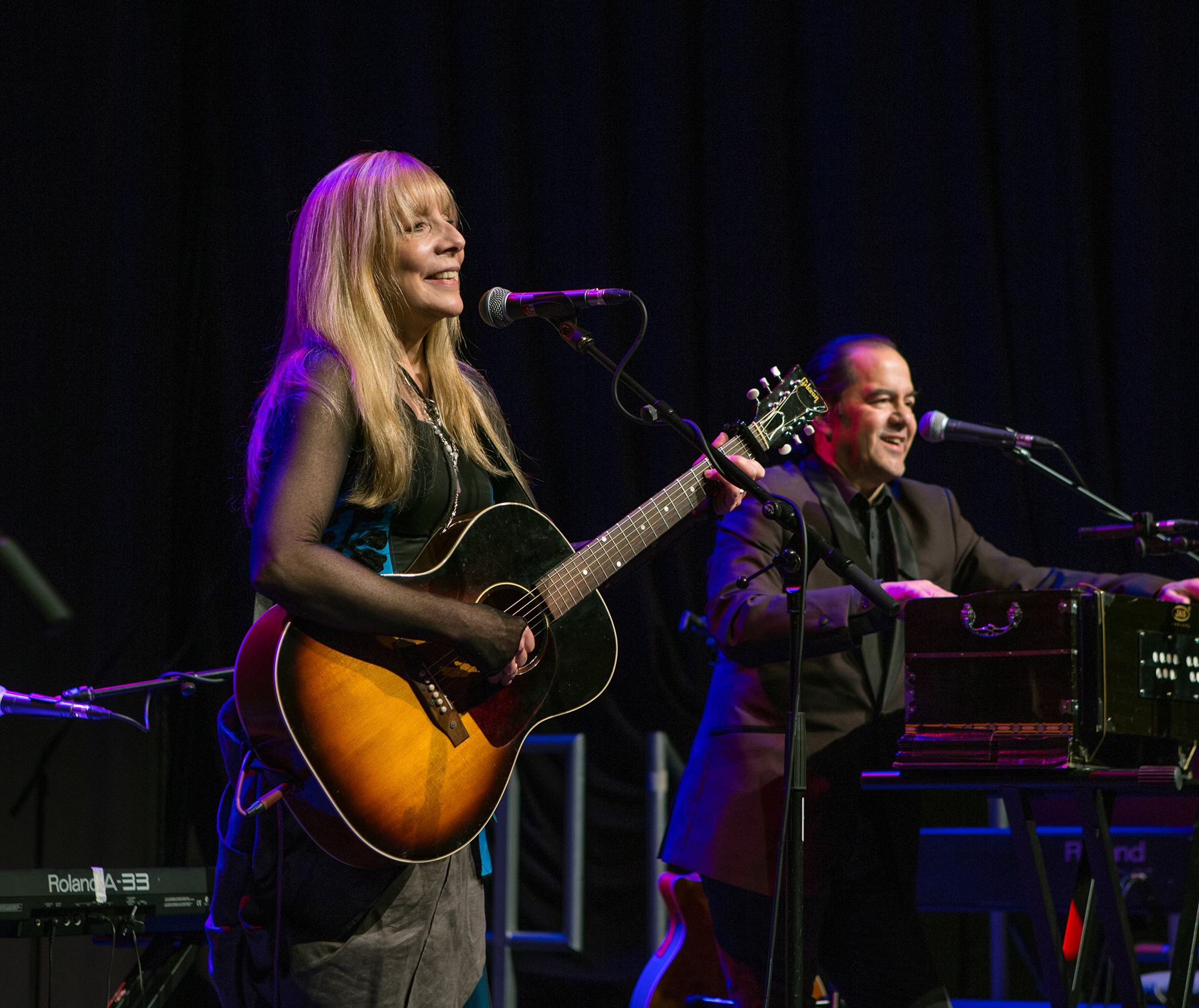 charlie dore and julian littman on stage playing guitars